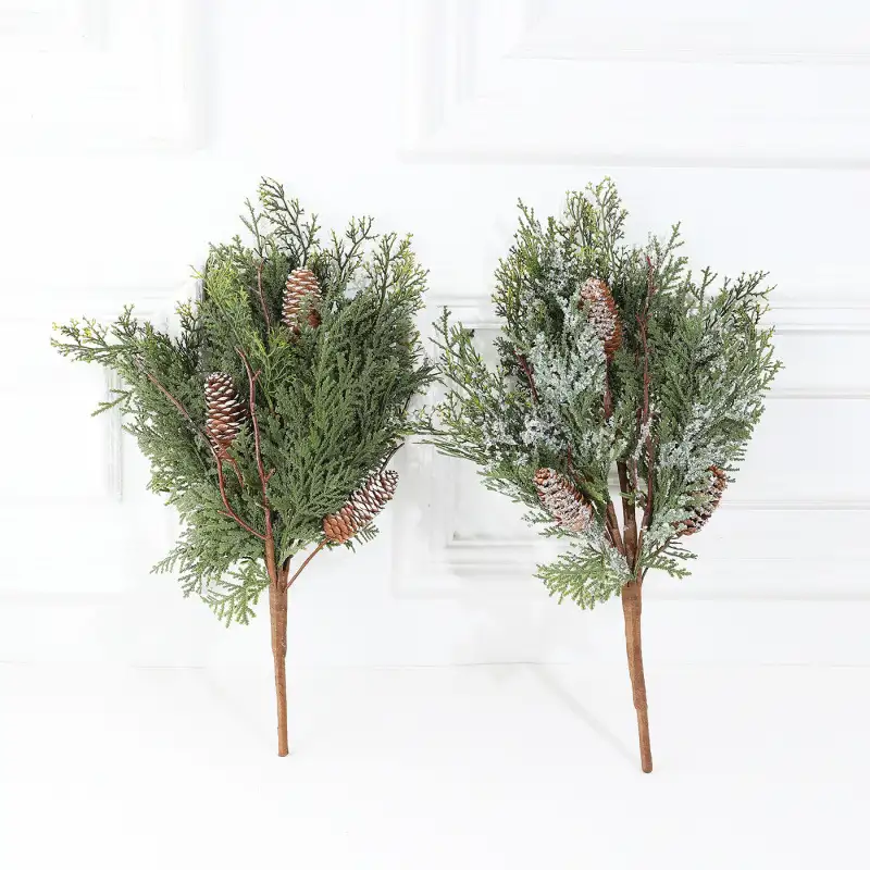 Artificial cedar branch decoration with red berries and pine cones