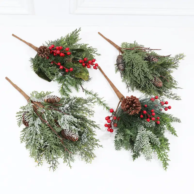 Artificial cedar branch decoration with red berries and pine cones